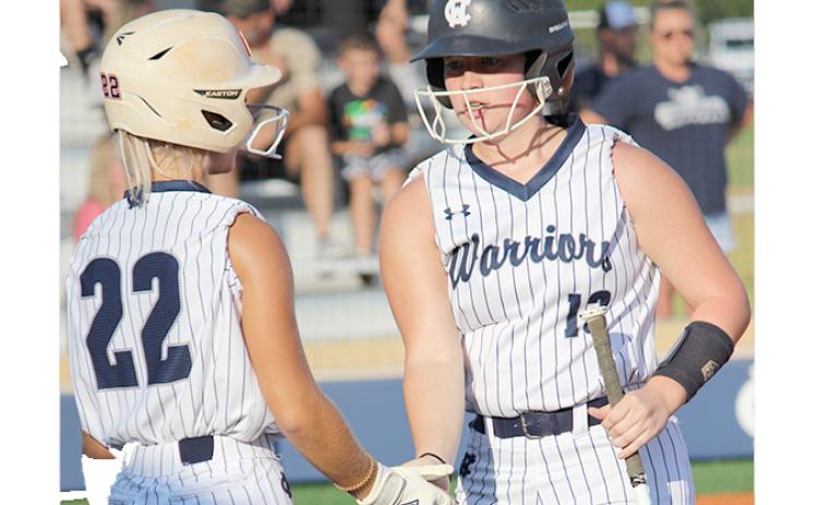 Emma Hare, left, congratulates Gabby Whiddon after scoring a run in sixth inning during the region win Monday over West Hall. (Photo/Mark Turner)