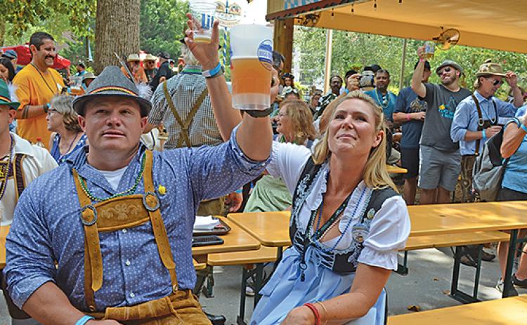 Michael and Kristina Cromer toast with the crowd. (Photo/Samantha Sinclair)