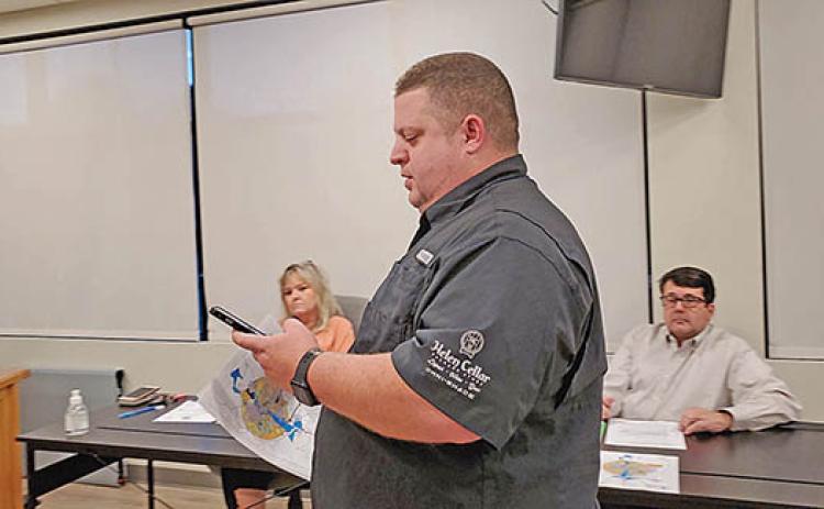 Justin Whitmire approaches the Cleveland Alcohol Review Board to show what he saw when zooming in on the city’s map. (Photo/Samantha Sinclair)