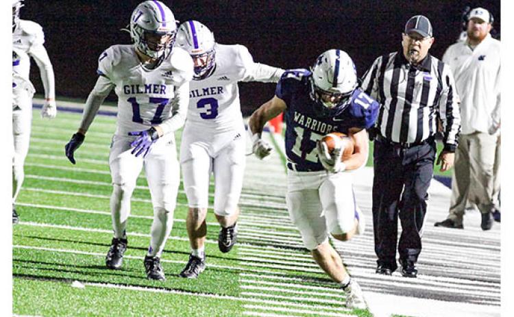 WCHS running back Ryan Fowler tiptoes down the sideline for a long run during the Warriors' 35-28 win over Gilmer in the regular season finale last Friday at Warrior Stadium. (Photo/Staci Sulhoff )