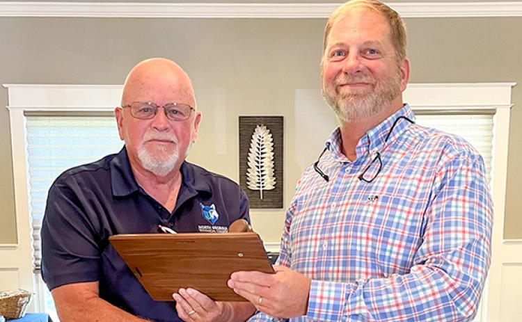 Outgoing chairman Mitchel Barrett passes the gavel to incoming chairman Gilbert Barrett. (Photo/submitted)