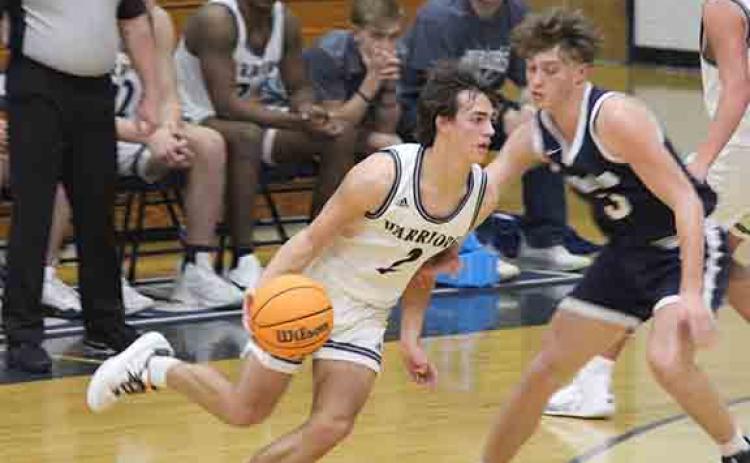 White County's Tripp Nix drives past West Hall's Landen Bennett during the second half of the region game in Cleveland. (Photo/Eli Shoemake)