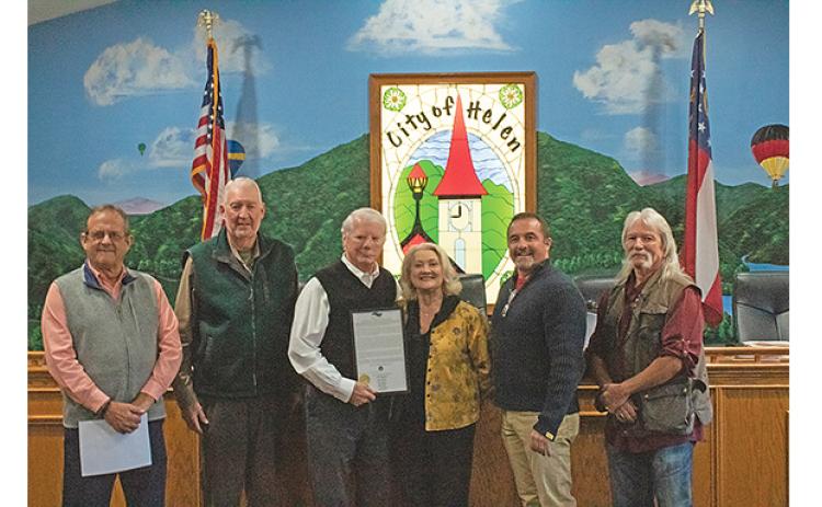 Commissioners Lyn Holcomb, Edwin Nix, Craig Bryant and Chairman Travis Turner present Mayor Jeff Ash and his wife, Paula with the proclamation making Dec. 12 Jeff Ash Day. (Photo/Noah Johnson)
