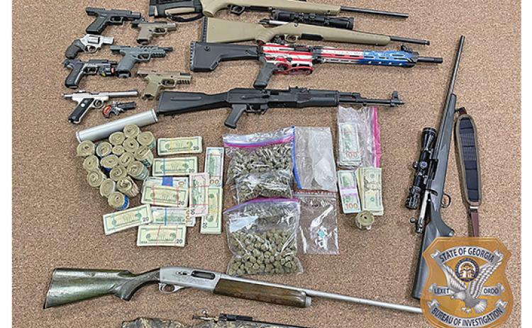 Guns, drugs and money found in the home of Michael Thompson of Cleveland. (Photo/submitted)