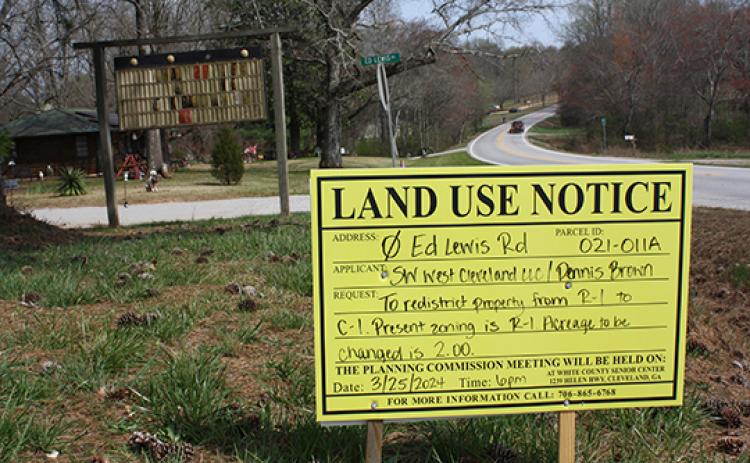 A sign placed off of Ed Lewis Road gives information about the public hearing. A Dollar General store is proposed for the property, requiring a zoning change. (Photo/Eric Tiongson)