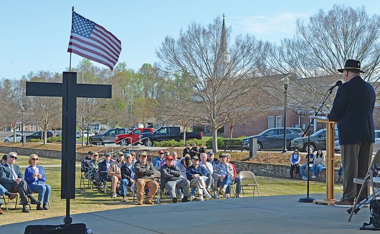 Col. Cal Riley, a combat veteran, shares his memories of the Vietnam War as a crowd of about 60 people listen. (Photos/Samantha Sinclair)