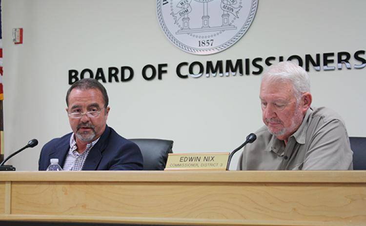 Chairman Travis Turner and Commissioner Edwin Nix discuss Sullivan Wickley’s request to rezone land off of Ed Lewis Road. (Photo/Eric Tiongson)