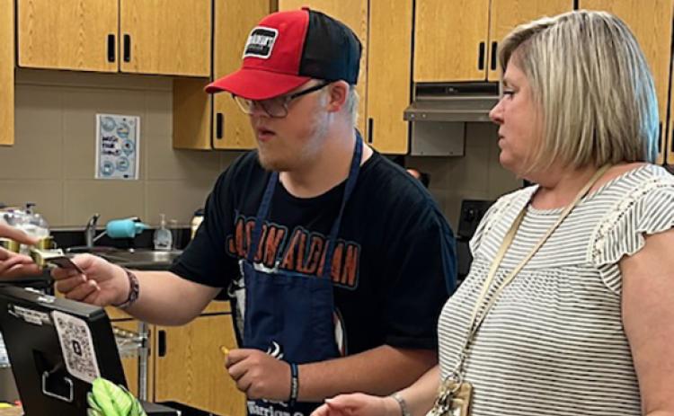 Nathan Anderson and Shauna Emig work as a team during the morning rush at the Warrior Cafe Coffee Cart. (Photo/Jane Grillo)