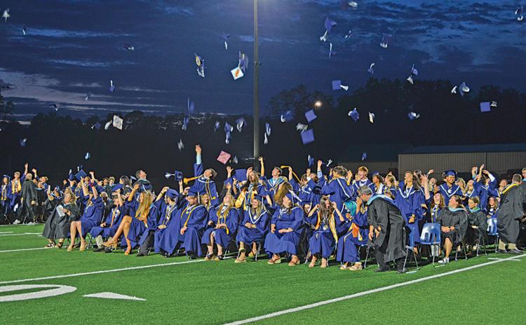 The Class of 2024 tosses their caps in the air Friday night moments after Principal Mary Anne Collier sends them off by saying, “Class dismissed.” (Photo/Samantha Sinclair)