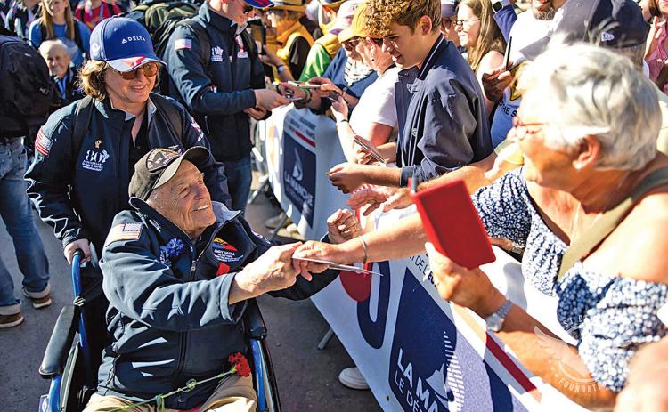 Virginie Durr helps Andy Negra meet his fans at the Ste Mere Eglise Parade on June 9. (Photo/Jerome Pollos Photography)