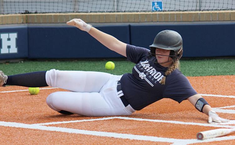 White County's Cierra Bailey slides and reaches back to touch the plate Monday morning's practice session at the softball complex. (Photo/Mark Turner)