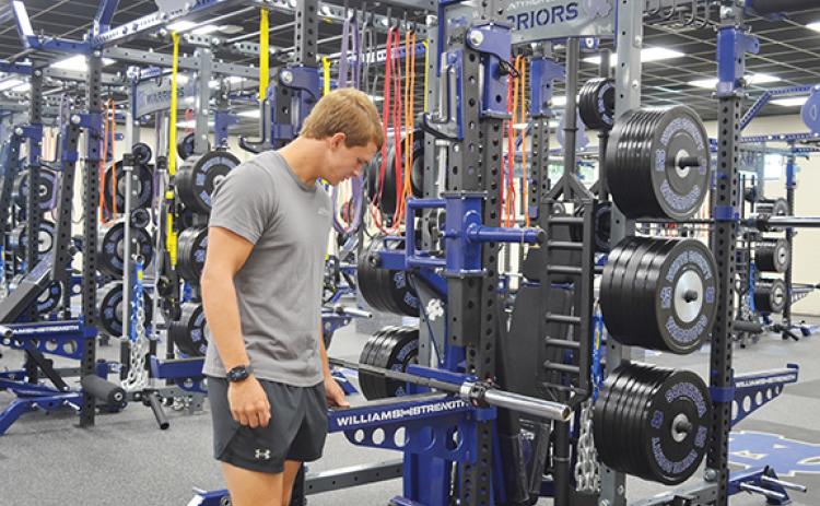 WCHS senior Dade Anderson checks out the equipment in the new weight room  during open house Tuesday afternoon at the high school. (Photo/Samantha Sinclair)