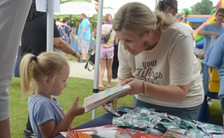 Noelyn Blount gets a new book to read from Tesnatee Gap Elementary Principal Noel Cochran. (Photo/Ollie Osborne)