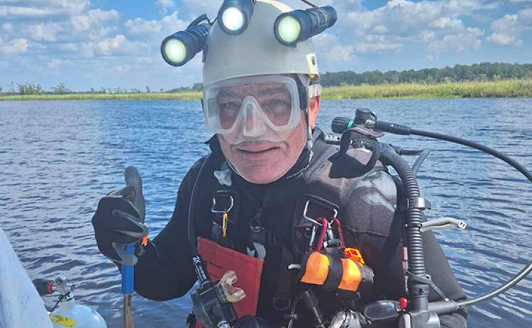 David Smith gives a thumbs-up before diving in to hunt for fossils. (Photo/submitted)