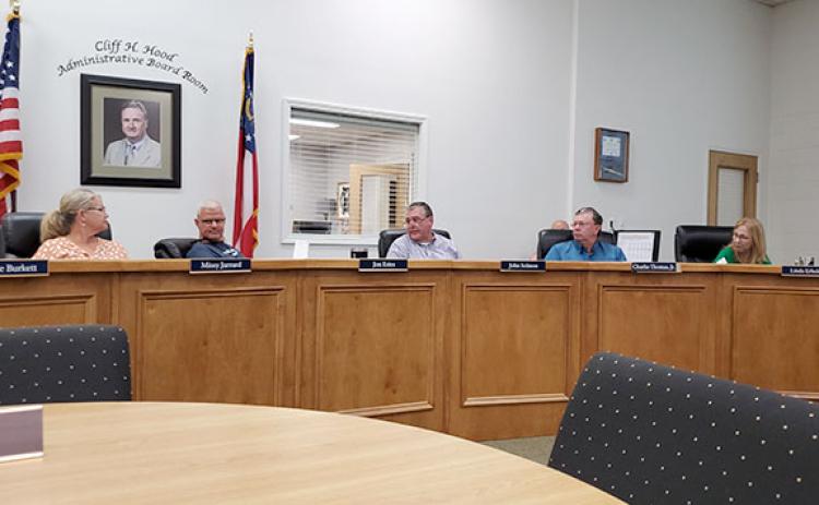 School board members Missy Jarrard, Jon Estes, John Solmon, Charlie Thomas and Linda Erbele discuss the rolling back the millage rate Tuesday morning. (Photo/Samantha Sinclair)
