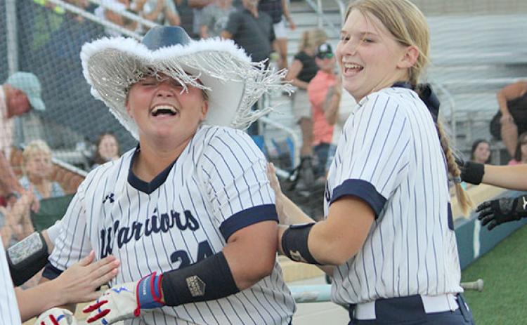 White County's Logan Fain, left, celebrates with Cierra Bailey moments after hitting a two-run home run in the bottom of the seventh inning to give the Lady Warriors an 8-6 win over North Hall in a Region 6-AAA game Monday at the WCHS softball complex. (Photo/Mark Turner)