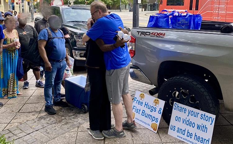 Jeff Edrington offers free hugs to a line of homeless people in Atlanta. (Photo/submitted)