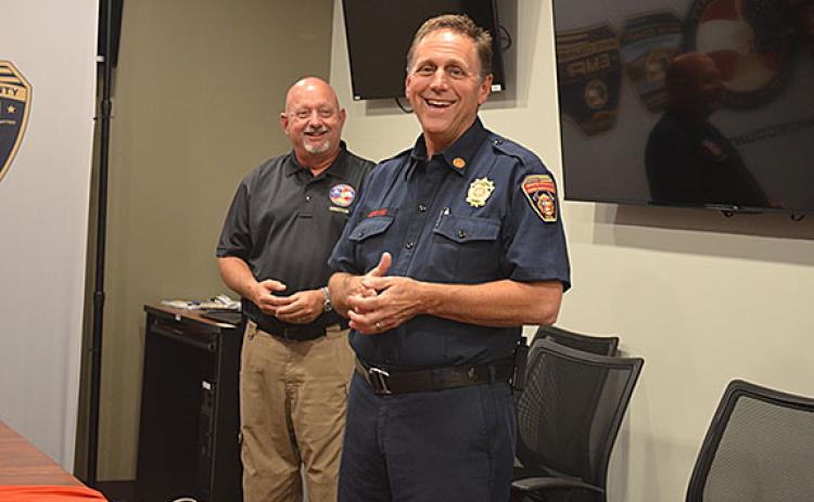 As Public Safety Director David Murphy smiles along in the background, Fire Chief Michael LeFevre shares his joy of having served White County. (Photo/Samantha Sinclair)