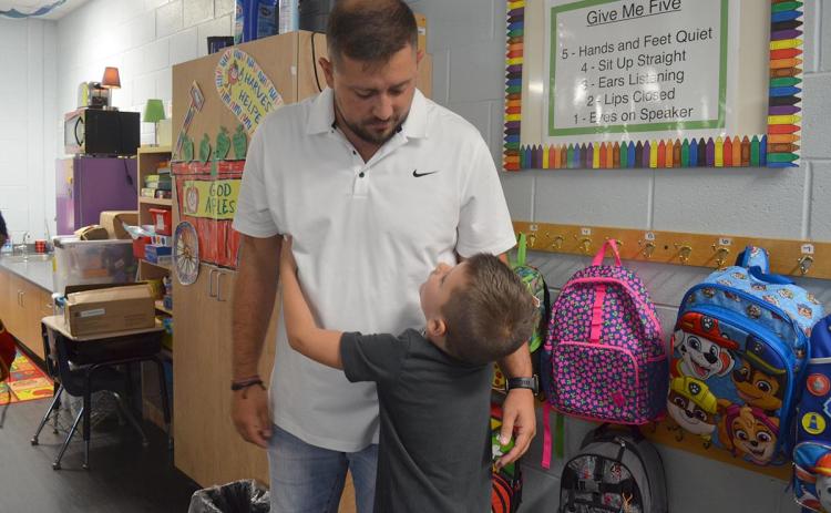 Rylan Tanner gives his dad one of many hugs before starting his first day of kindergarten in April Teems’ classroom at Mt. Yonah Elementary School. (Photo/Samantha Sinclair)