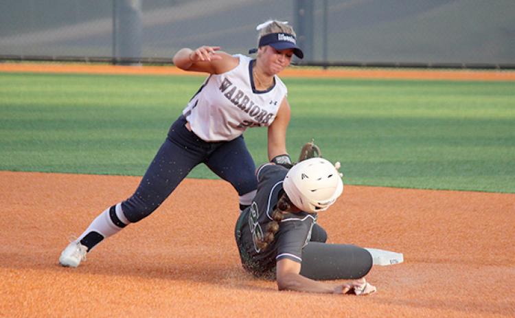 Emma Hare puts a tag on North Hall's Genesis Satterfield on a close play at second base during the region matchup Monday afternoon in Cleveland.(Photo/Mark Turner)