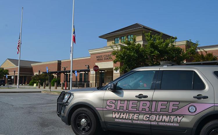 Flags remain at half staff to honor victims of the Apalachee High School tragedy on Tuesday at White County Middle School. On Monday, the school was the subject of a threat posted on social media. (Photo/Samantha Sinclair)