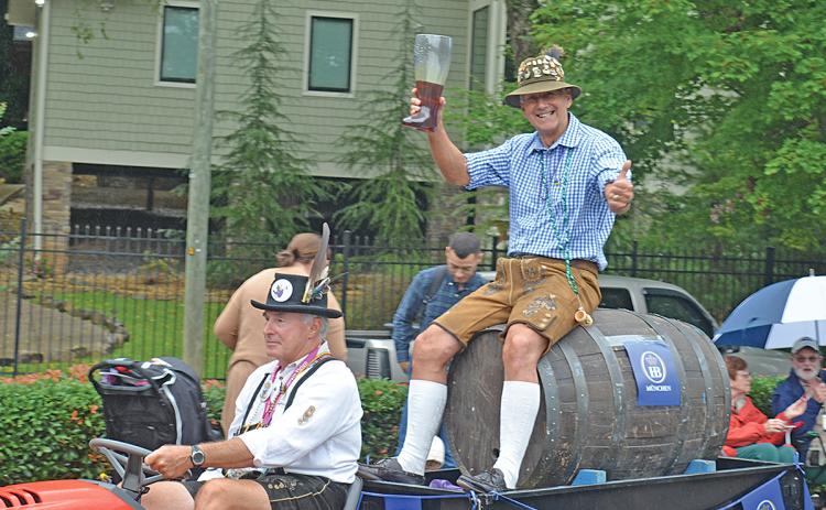 David Hartis, the official keg tapper, pulls the first official keg of Oktoberfest, ridden by John Hauza. (file photo)