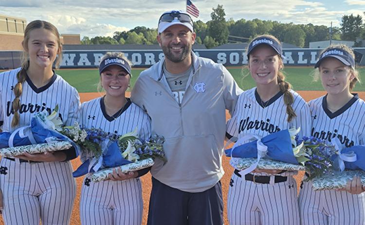 White County knocked off Forsyth Central 5-4 Tuesday night to cap off Senior Night festivities. Shown above are seniors, from left, Hailey Ramey, Emma Hare, WCHS head coach Drew Owens, Aubrey Bolton and Lauren Black. (Photo/Mark Turner)