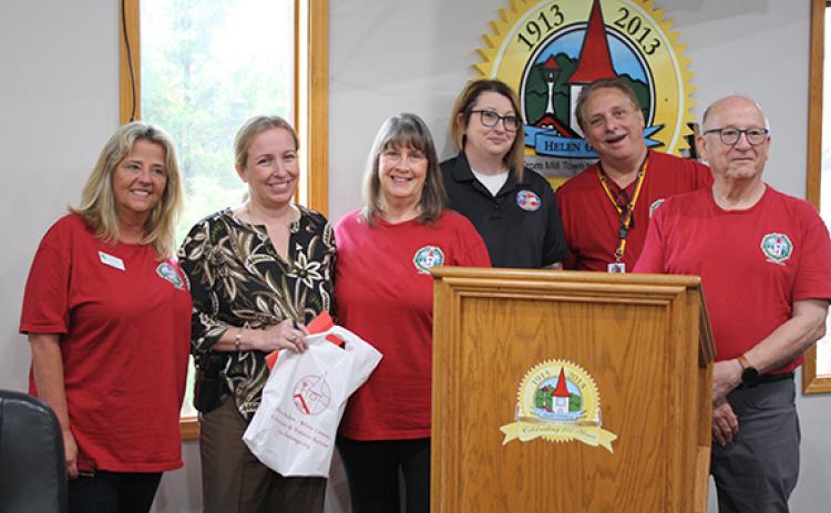 Fundraisers Doris Skelton, Pam Summers, Jessica Wood, Randy Summers and Dennis Doll present Helen Police Chief Aletha Barrett with money raised for the White Christmas for Kids fund at the Helen City Commission meeting. (Photo/Eric Tiongson)