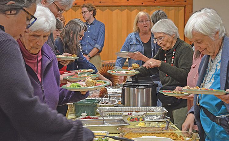Guests fill their plates with food at last year’s Annual Thanksgiving Dinner at the Sautee Nacoochee Center. (Photo/Samantha Sinclair)