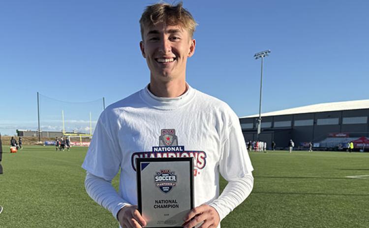 Iyan Windham shows off the NAIA plaque after national championship game Monday in Kansas.  (Photo/Submitted)