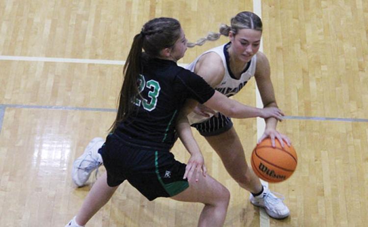 White County's Bree Burkett tries to drive past Pickens' Bella Martin during the region game.