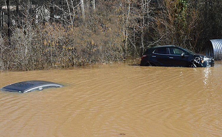 Three inches of rain Feb. 13 caused a sinkhole in the staff parking lot of Dalton Family Eyecare on US Hwy. 129 on Feb. 14 that totally submerged a car in water. (Photo/Submitted)