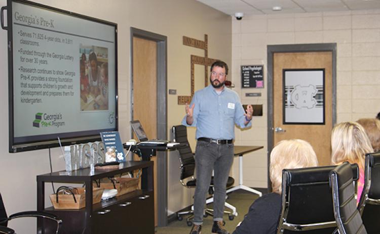 Clayton Adams, a community coordinator with the Georgia Department of Early Care and Learning, speaks to local educators and community advocates about the necessity of quality child care during a March 21 Family Connections meeting at the White County School System administrative office. (Photo/Denise Etheridge)