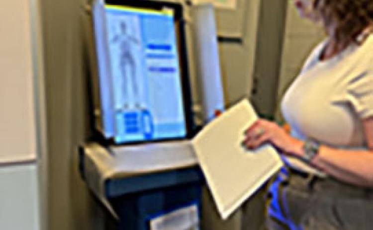Accreditation Manager Amber Donaldson demonstrates the scans that jailers examine to be sure an inmate hasn’t brought something into the jail. (Photo/Linda Erbele)
