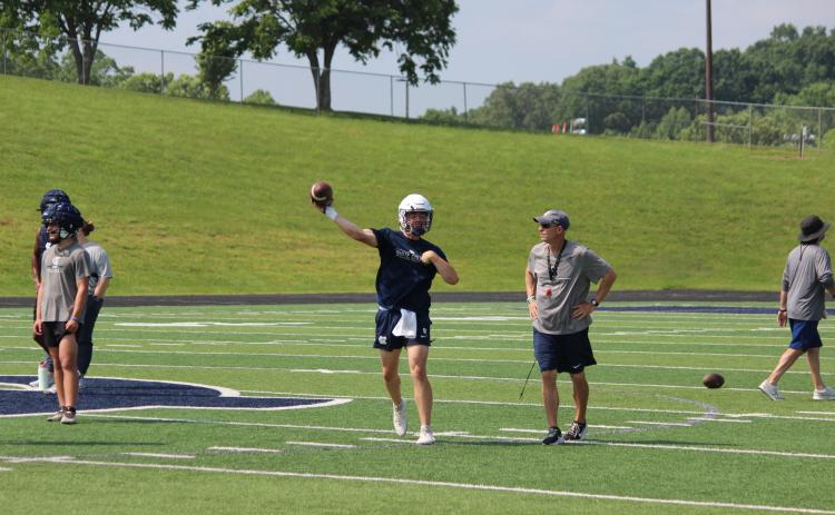 WCHS quarterback Alex Freeman rips a pass downfield durning a drill in Tuesday's workout session. (Photo/Mark Turner)
