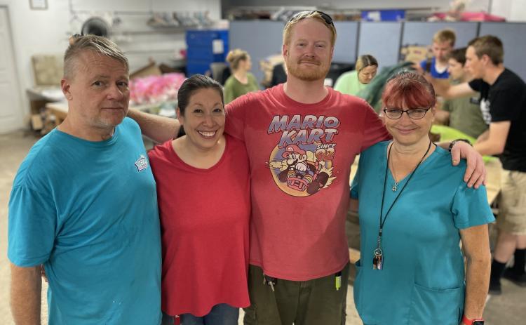 His Hands and Feet Ministry Thrift Store’s monthly food drive is managed by, left to right, Rob Efferson, Shauna Efferson, Scotty Splittorff, and Lisa Ferrari. (Jerry Grillo photo))