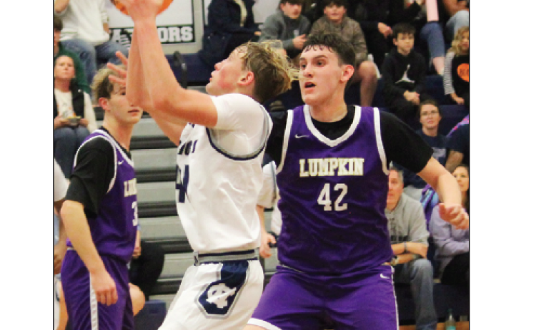 White County's Champ McCutcheon, left, puts up a shot in front of Lumpkin County's Brett Passmore during the eighth grade game Tuesday afternoon at WCMS. MARK TURNER /WCN