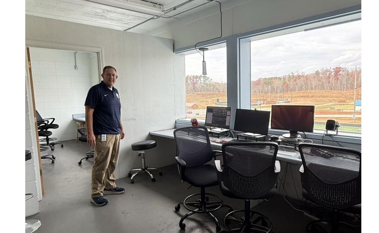 Assistant School Superintendent Jonathan Stribling points out possible repairs that could be made to the press box, should the school board approve the project.