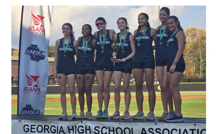 The WCHS girl's team shows off some hardware following their fourth place finish in the Class AAA meet Saturday in Carrollton. Shown are, from left, Alexis Kelley, Angela Lozada, Julie Black, Carly Black, Darla Wright, Maddie Evans and Emma Windham. MARK TURNER/WCN