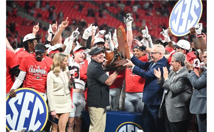 UGA head coach Kirby Smart picks up some hardware after the Georgia Bulldogs rolled past Alabama last weekend in the SEC Championship game in Atlanta. KEITH BARLOW/CNI