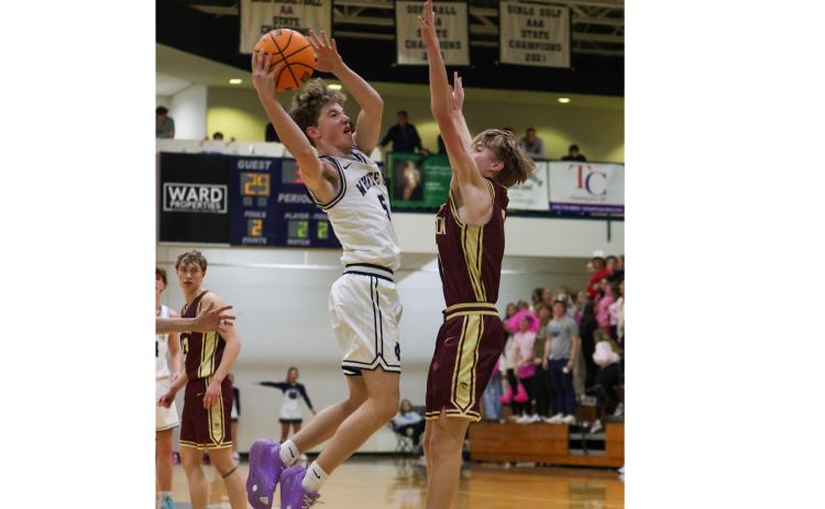 John Jarrard puts up a shot over a Dawson County defender during the region game last Friday in Cleveland.  JENNIFER KNIGHT/SPECIAL