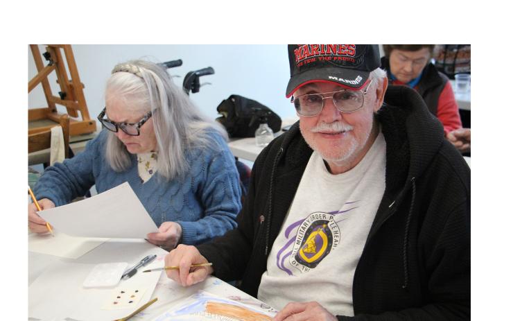 Rebecca LeCouter and Ed LeCouter, USMC Vietnam Veteran, work on painting watercolor windmills in last Thursday’s class. CARLY HENDERSON/WCN