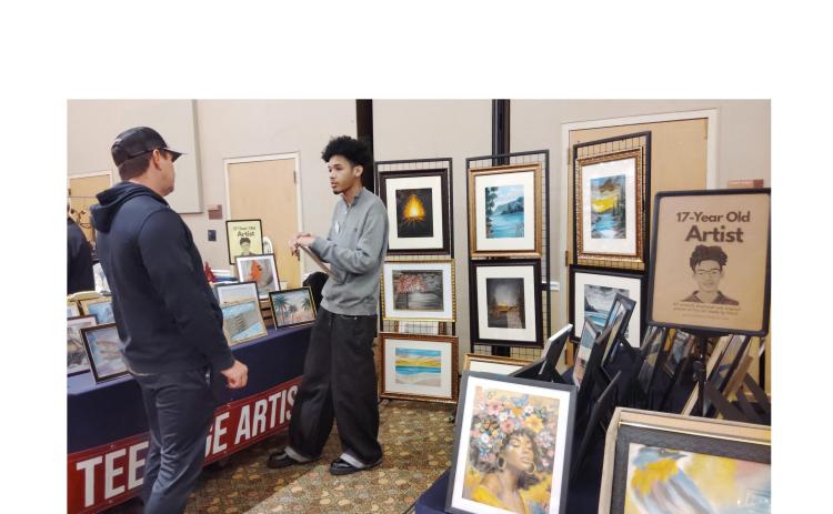 Artist Tyrus Mosley, 17, of Covington speaks with a visitor to Unicoi State Park & Lodge during WinterFest last Saturday. DENISE ETHERIDGE/WCN