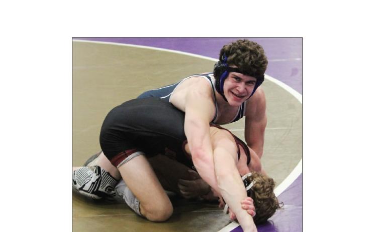 "Josh Lane flashes a smile during the final seconds of the 144-pound championship match last week at the Area 6-AAA tournament. MARK TURNER/WCN
