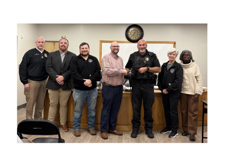 From left, Cleveland Police Chief Jeff Shoemaker, Council members CJ McDonald and Jeremy McClure, Mayor Josh Turner, Officer David Bruce, and Council members Nan Bowen and Annie Sutton gather as Bruce is recognized as the 2025 Officer of the Year at the March 2 meeting of the Cleveland City Council. CARLY HENDERSON/WCN