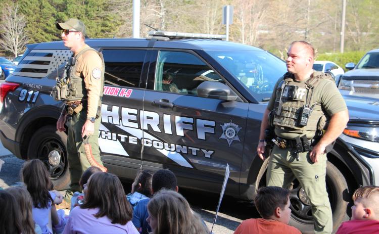 Deputies Zack Lathem, left, and Deputy and School Resource Officer Dylan Loggins, right, (and K-9 Jelly) speak with students and answer questions during Career Day. PHOTOS BY CARLY HENDERSON/WCN