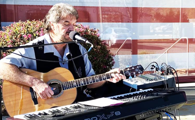 Musician Kurt Johnson provides music for the Vietnam War Veterans Day observance in Freedom Park.