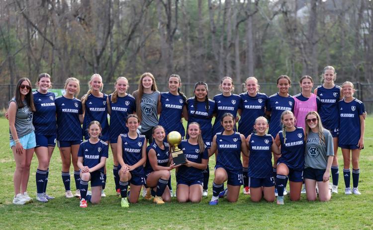 The Lady Warriors show off the NGML trophy after beating Lumpkin County 4-1 in the championship game last week at the WCMS Warrrior Stadium. JENNIFER KNIGHT/SPECIAL