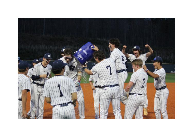 Alex Freeman, right, dumps a water cooler on Noah Thomas after Thomas gave the Warriors' a walk-off win over Lumpkin County in Game 2 of the series last Thursday in Cleveland. MARK TURNER/WCN