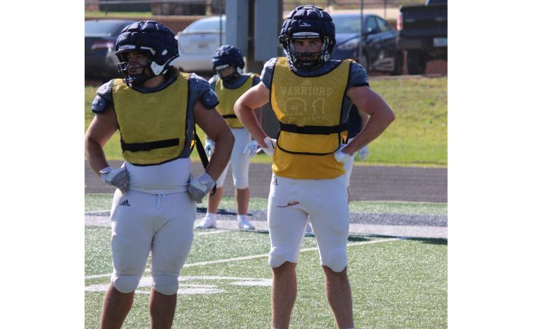 Mikey Moreno, left, and James Hart get a defensive call during the team's practice Tuesday afternoon at Warrior Stadium.  MARK TURNER/WCN